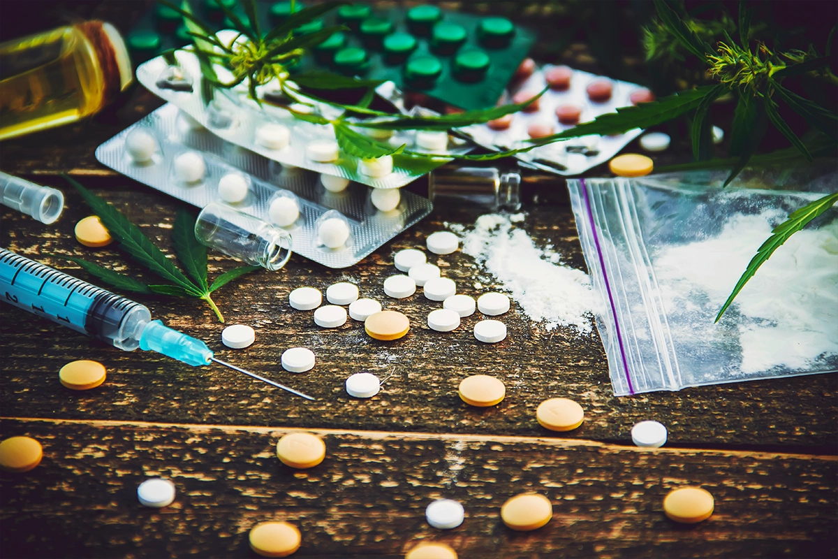 A variety of drugs laid out on a wood table