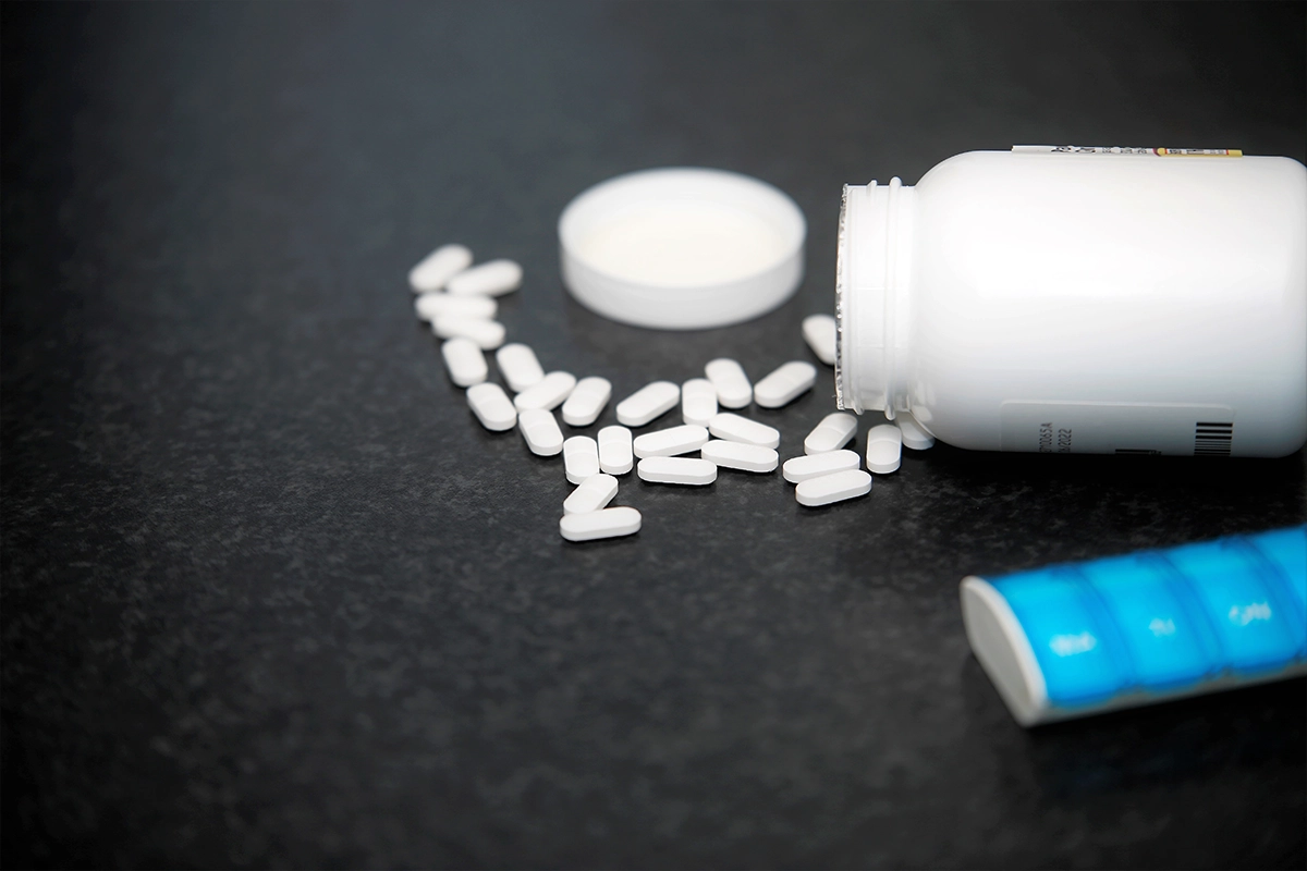 Bottle of Xanan with pills scattered across table